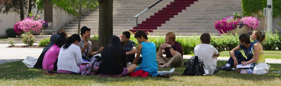 Hendricks Circle Students in circle on grass outside Hendricks Chapel
