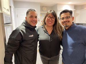 Photograph of 3 education faculty during Prof. Amanda Tachine's visit to SU. Prof. David Perez, higher education, Prof. Mario Perez, Cultural Foundations of Education, standing on either side of Prof. Tachine, Arizona State University